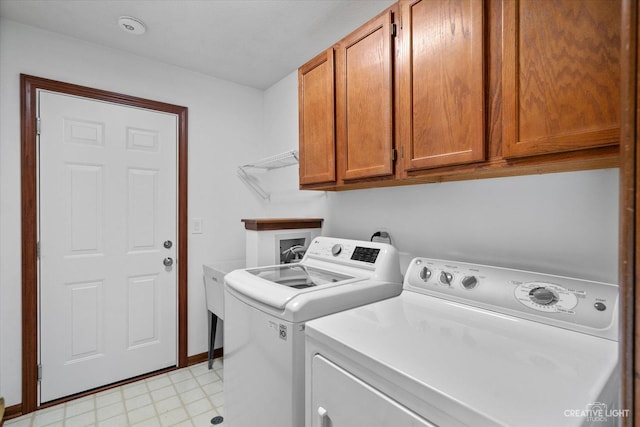 laundry area featuring washer and clothes dryer and cabinet space