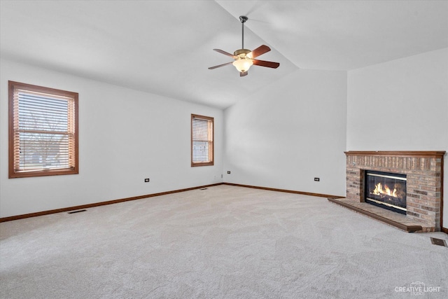 unfurnished living room featuring visible vents, a brick fireplace, ceiling fan, carpet, and vaulted ceiling