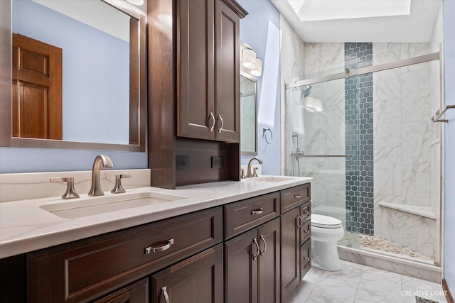 bathroom with a sink, a marble finish shower, marble finish floor, and double vanity