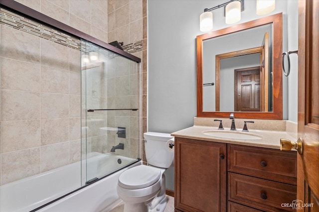 bathroom featuring toilet, vanity, and shower / bath combination with glass door