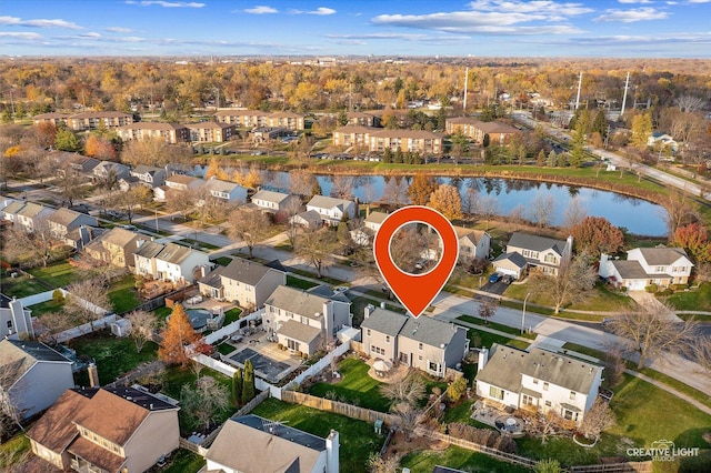 birds eye view of property with a residential view and a water view