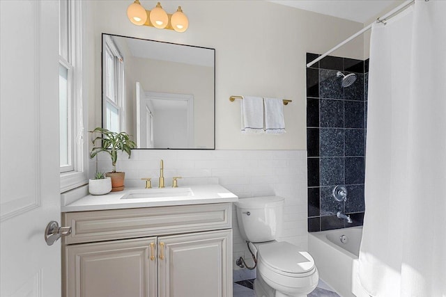 bathroom featuring toilet, shower / bath combo, tile walls, and vanity