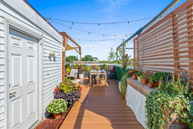 wooden terrace with outdoor dining space