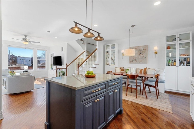 kitchen with a center island, pendant lighting, dark wood-style flooring, recessed lighting, and open floor plan