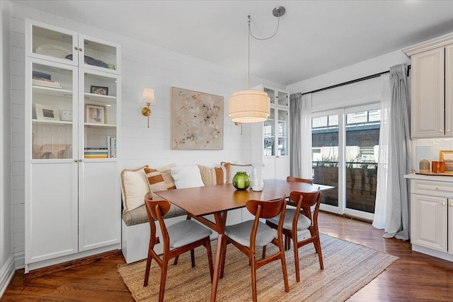 dining room featuring breakfast area and dark wood finished floors