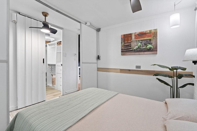 bedroom featuring wood finished floors and a ceiling fan