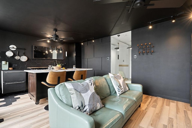 living room featuring light wood-type flooring and ceiling fan