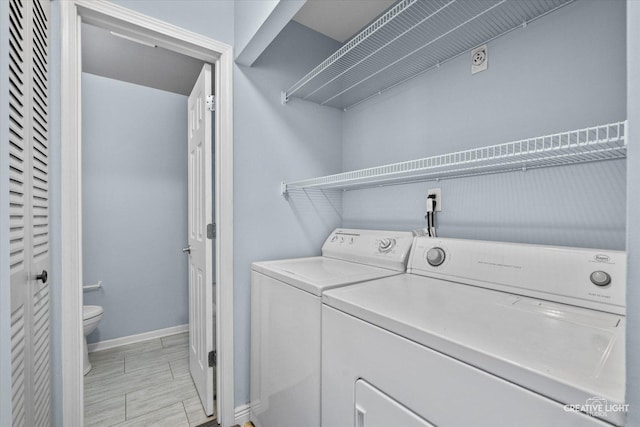 laundry area with washing machine and dryer, laundry area, and baseboards