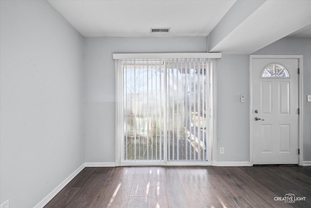 entrance foyer featuring visible vents, plenty of natural light, baseboards, and wood finished floors