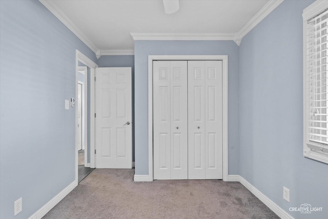 unfurnished bedroom featuring carpet floors, baseboards, and crown molding