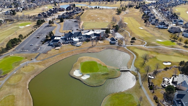 aerial view featuring golf course view, a water view, and a residential view