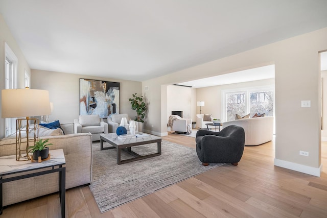 living room with light wood-style flooring and baseboards