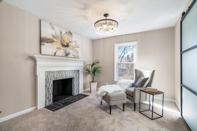 sitting room featuring carpet floors, a barn door, baseboards, and a tiled fireplace