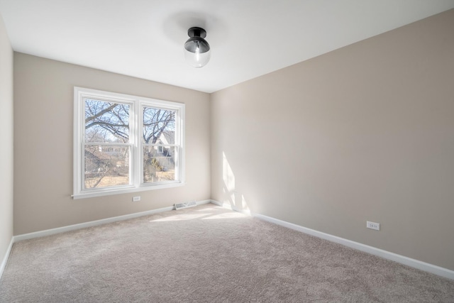 carpeted empty room with baseboards and visible vents