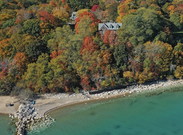 aerial view featuring a water view and a forest view