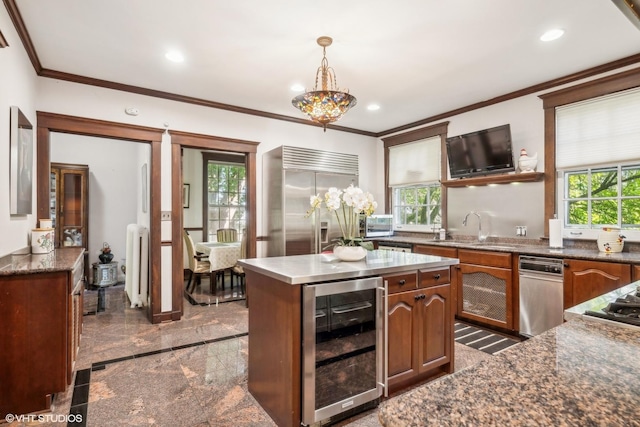 kitchen featuring wine cooler, radiator, built in refrigerator, and a healthy amount of sunlight