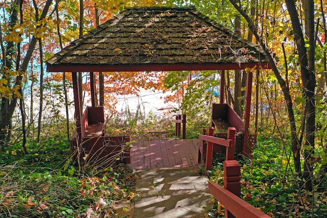 wooden terrace featuring a gazebo