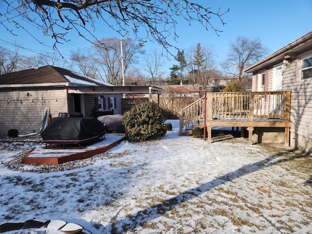 snowy yard with a wooden deck