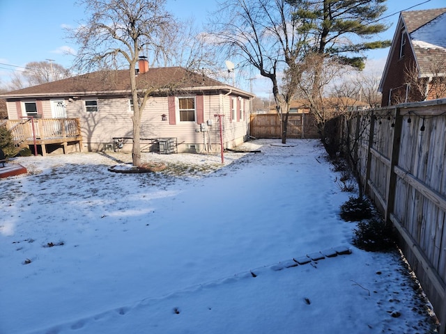 exterior space featuring a fenced backyard, a chimney, and a deck