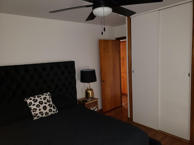 bedroom featuring ceiling fan, a closet, and wood finished floors