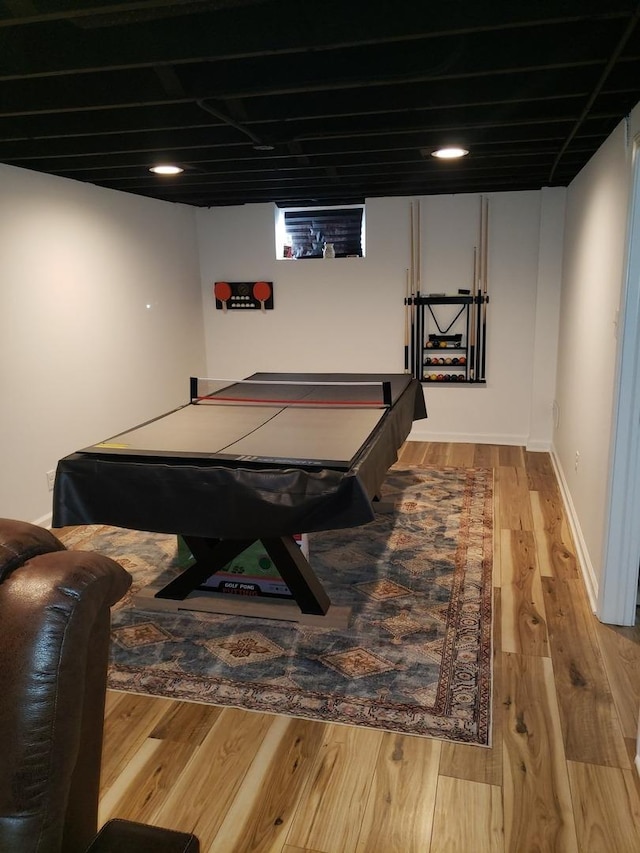 recreation room with baseboards and wood finished floors