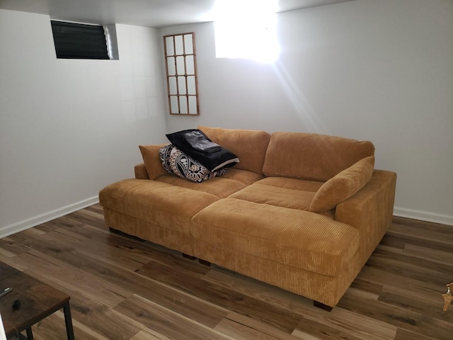 living area featuring baseboards and wood finished floors