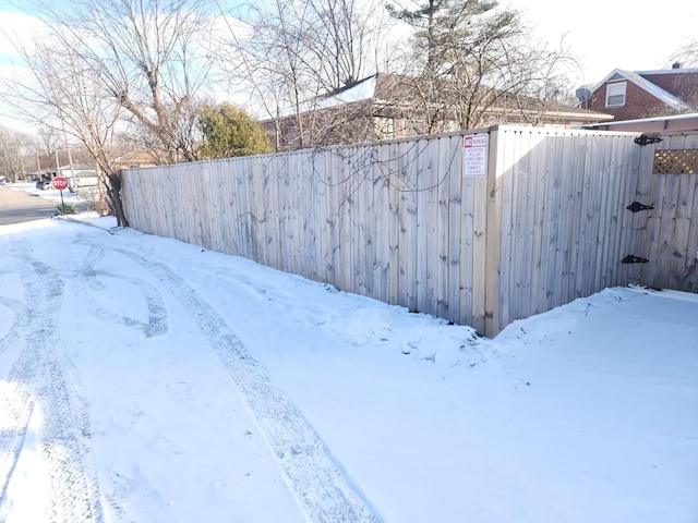 yard covered in snow with fence