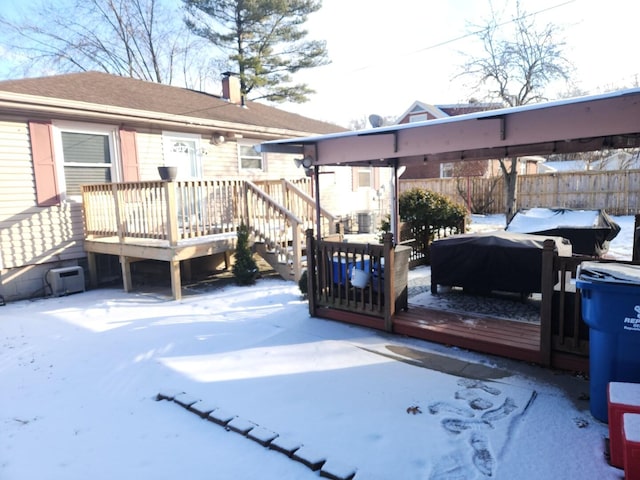 snow covered deck with fence