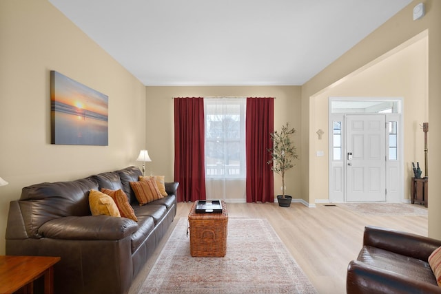 living room with light wood-style flooring and baseboards