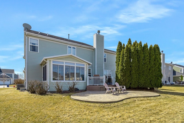 rear view of property featuring a patio and a lawn