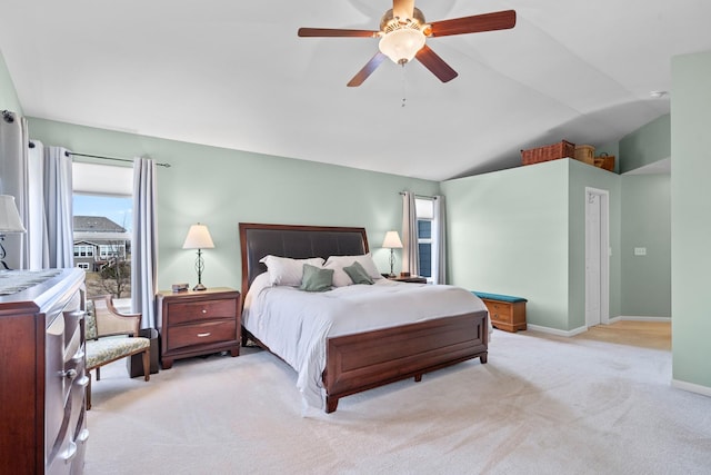 carpeted bedroom with baseboards, lofted ceiling, and a ceiling fan