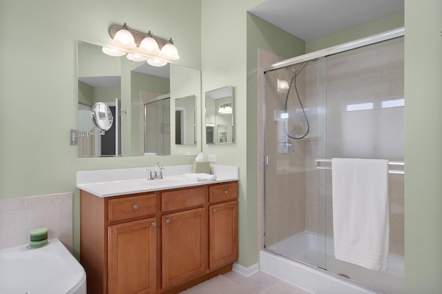 bathroom with a stall shower and vanity