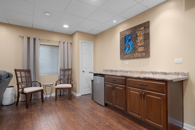 bar featuring dark wood-style floors, baseboards, recessed lighting, a paneled ceiling, and fridge