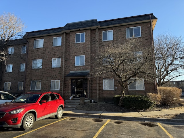 view of property featuring uncovered parking