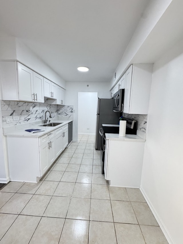 kitchen with light tile patterned flooring, stainless steel appliances, a sink, and light countertops