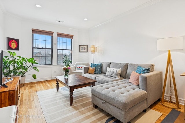 living room featuring recessed lighting, visible vents, light wood-style flooring, and crown molding