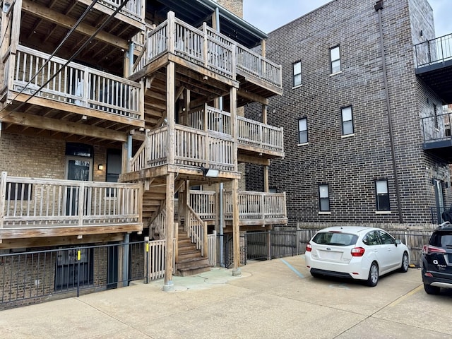 view of building exterior featuring uncovered parking