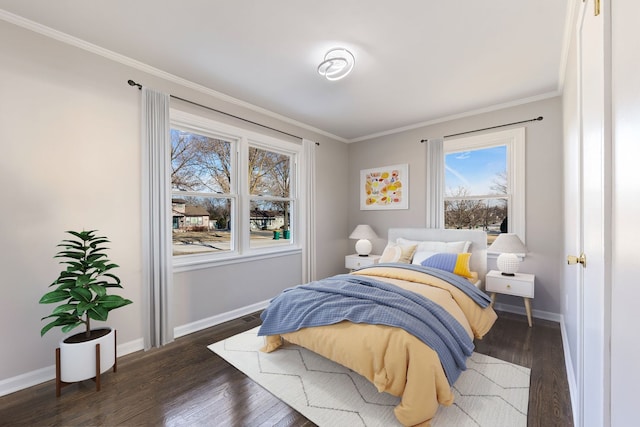 bedroom with crown molding, wood finished floors, and baseboards