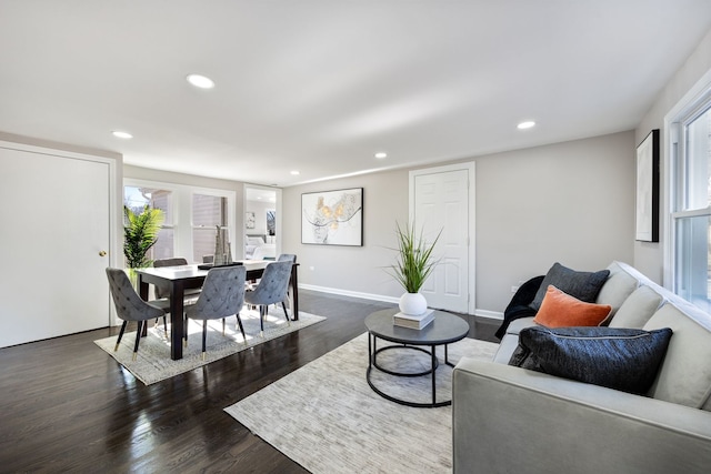 living room with dark wood-style floors, baseboards, a wealth of natural light, and recessed lighting