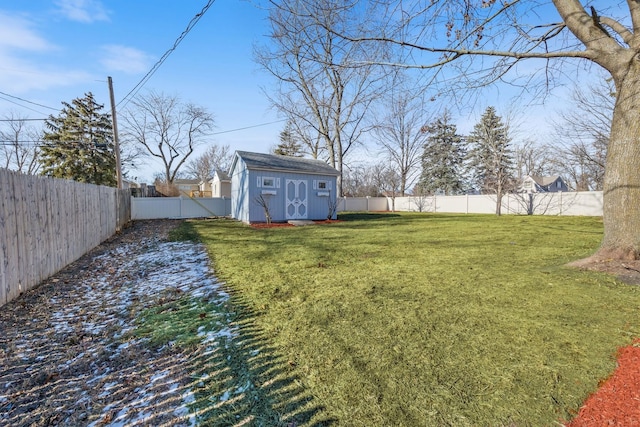 view of yard with a storage unit, an outdoor structure, and a fenced backyard