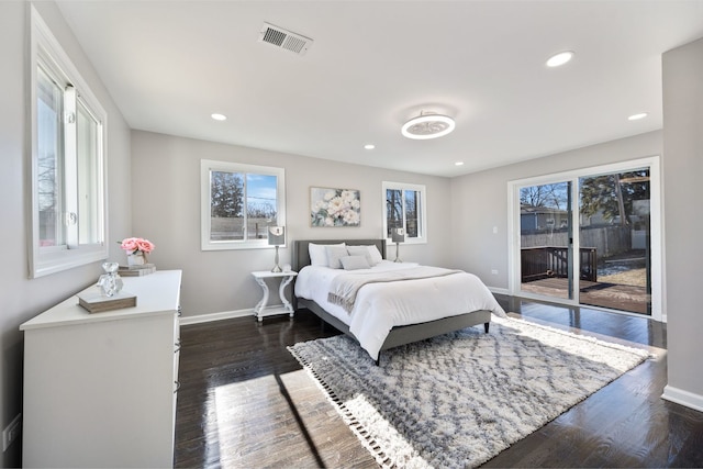 bedroom with access to exterior, baseboards, multiple windows, and visible vents