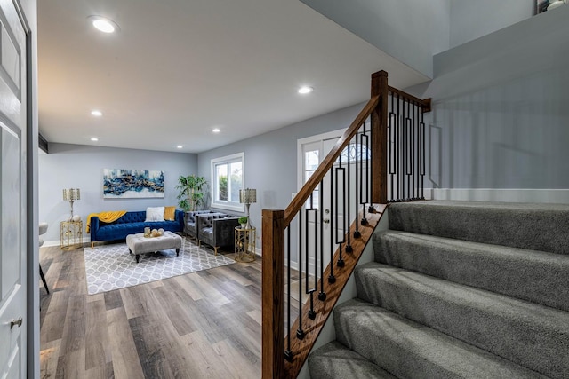 staircase featuring recessed lighting, baseboards, and wood finished floors