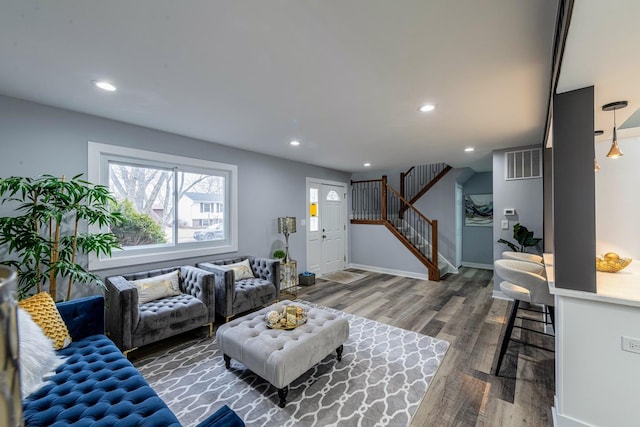 living room featuring recessed lighting, visible vents, stairway, wood finished floors, and baseboards