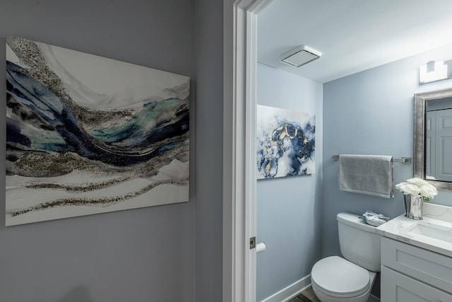 bathroom featuring vanity and toilet