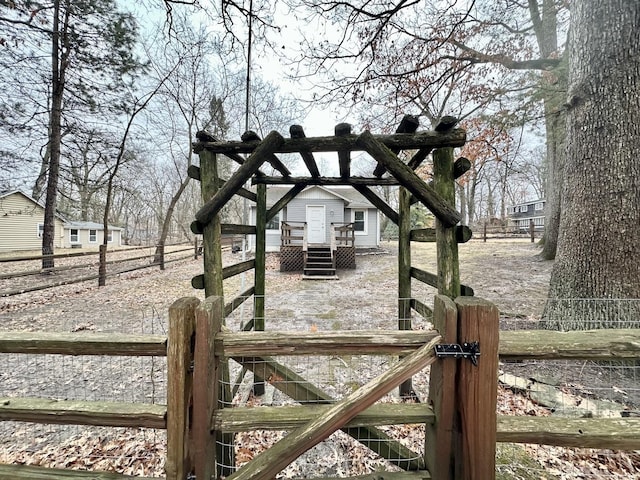 view of gate featuring fence and a wooden deck