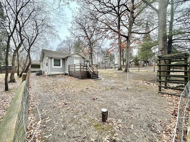 view of yard featuring fence and a deck