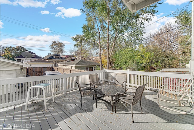 wooden terrace featuring fence