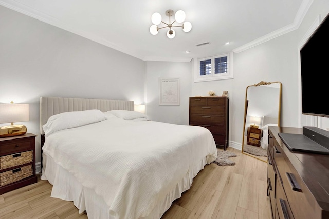 bedroom with visible vents, a chandelier, ornamental molding, and light wood finished floors