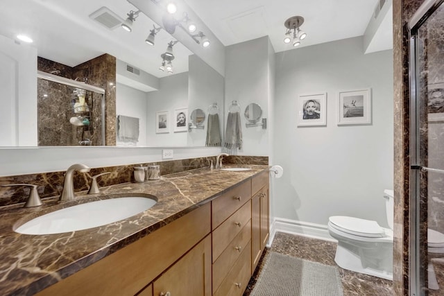 bathroom with visible vents, a shower stall, toilet, and a sink