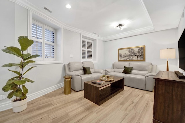 living area featuring visible vents, baseboards, light wood-style flooring, and crown molding